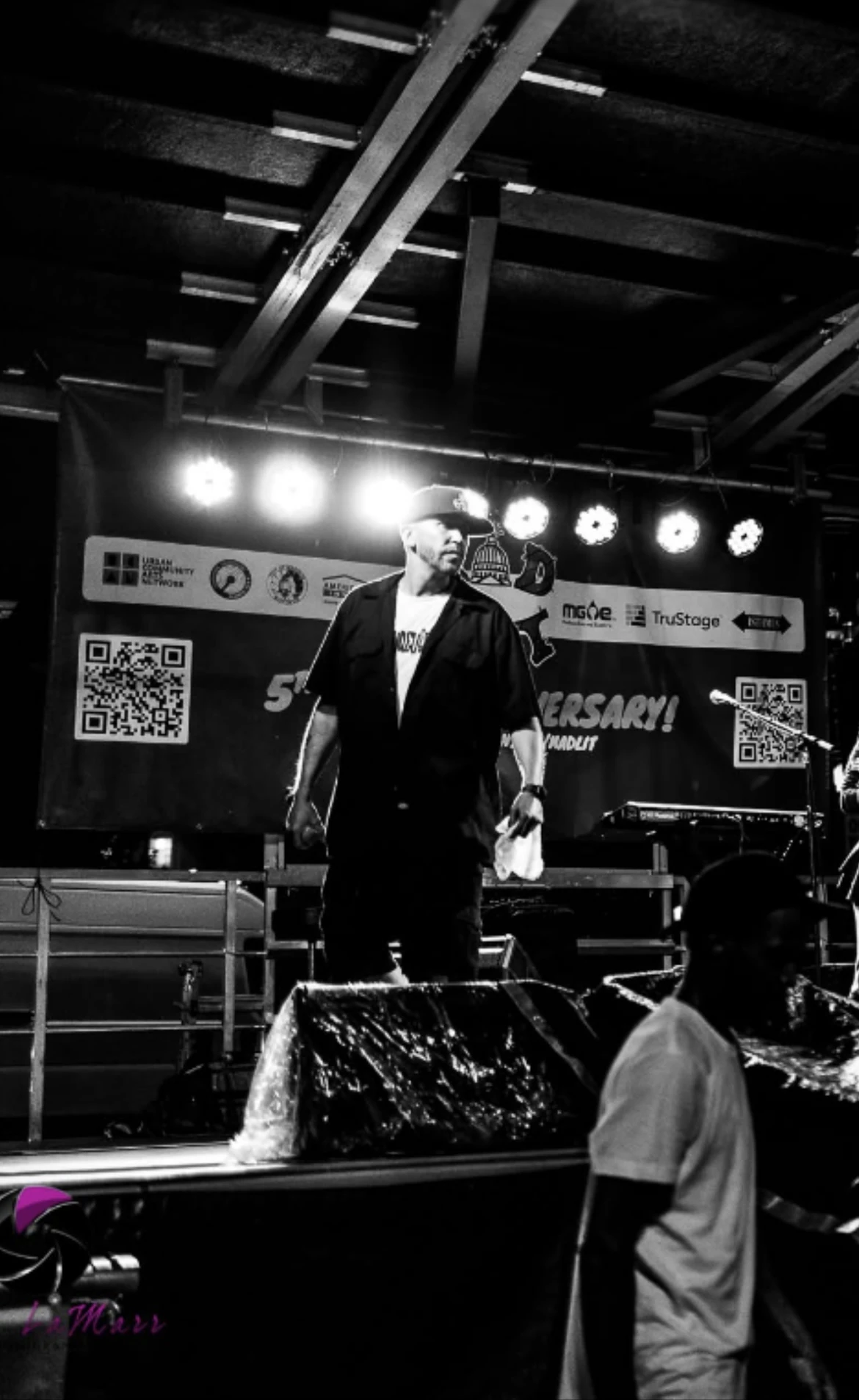 Bliz Gee performing on stage in black and white