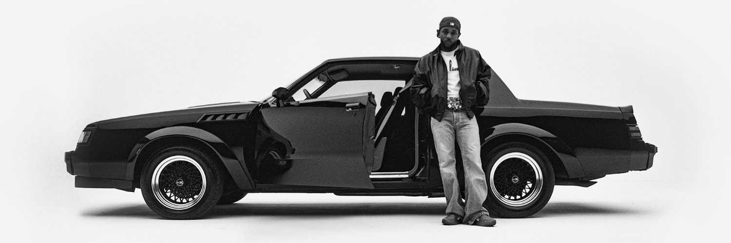 Kendrick Lamar standing beside the GNX car