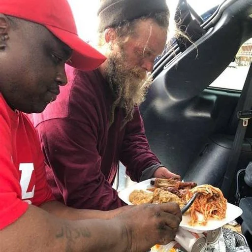Michael Airhart serving a meal during outreach