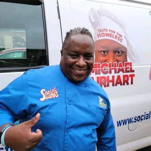 Michael Airhart beside Taste for the Homeless community vehicle