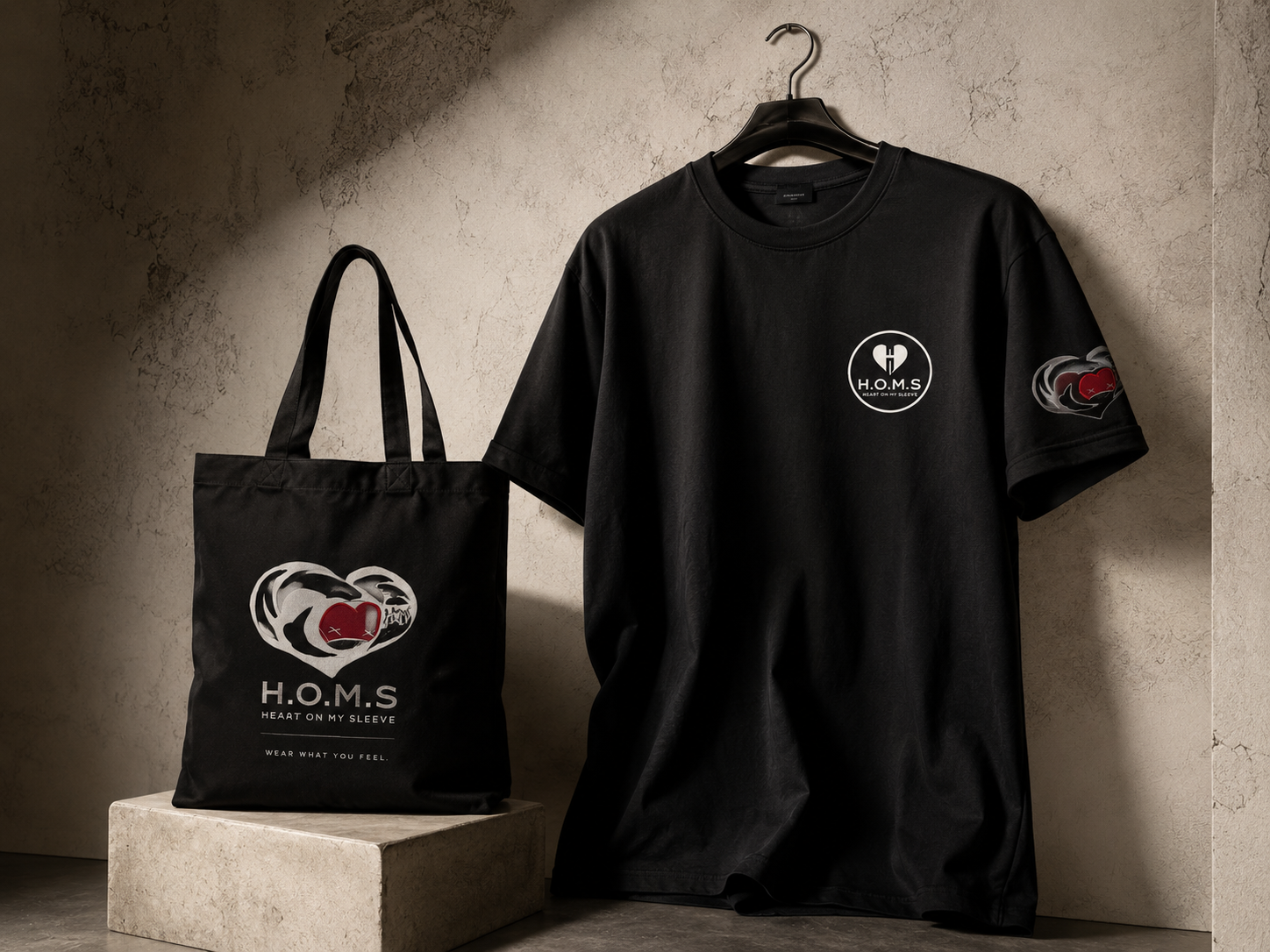 H.O.M.S. shirt and tote displayed together